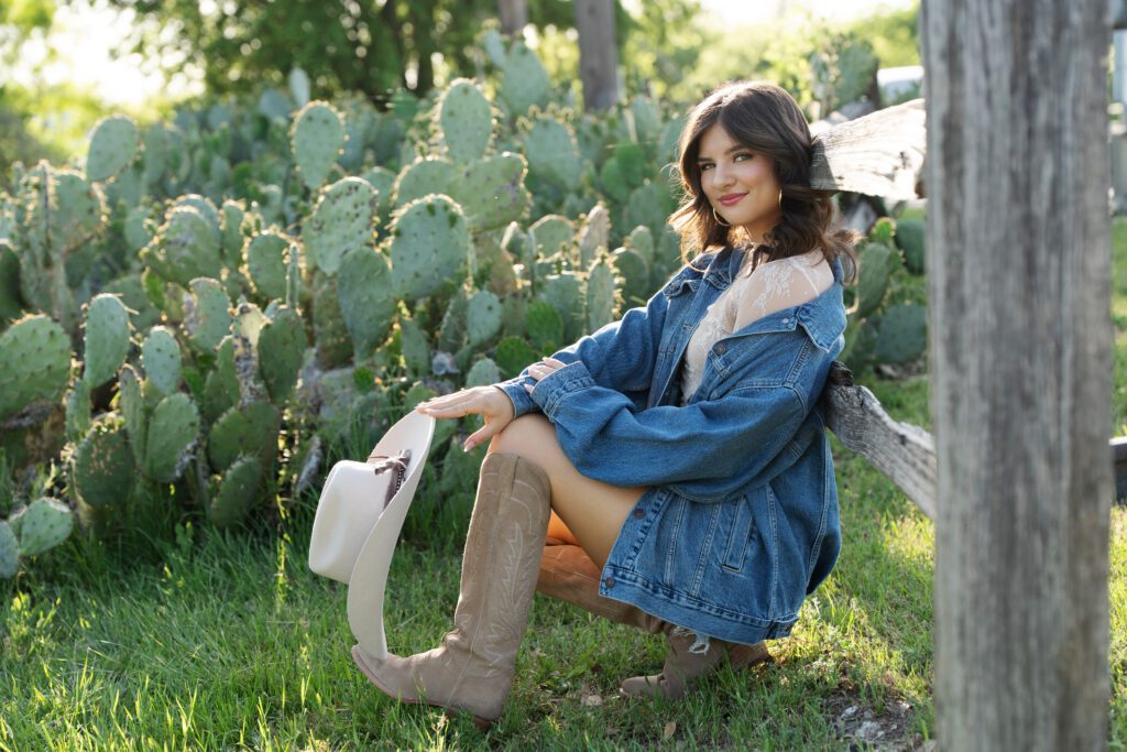 senior girl at Fort Worth Stockyards in Western outfit with Tecova boots