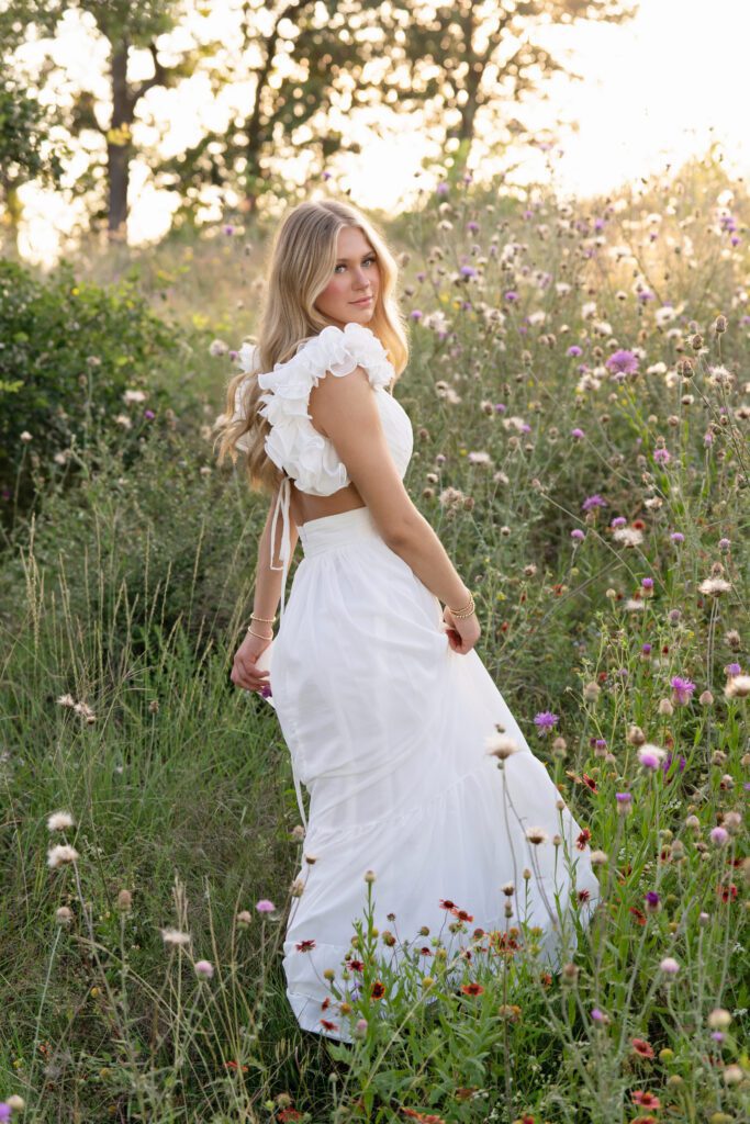 outdoor senior picture idea in flower field with white dress