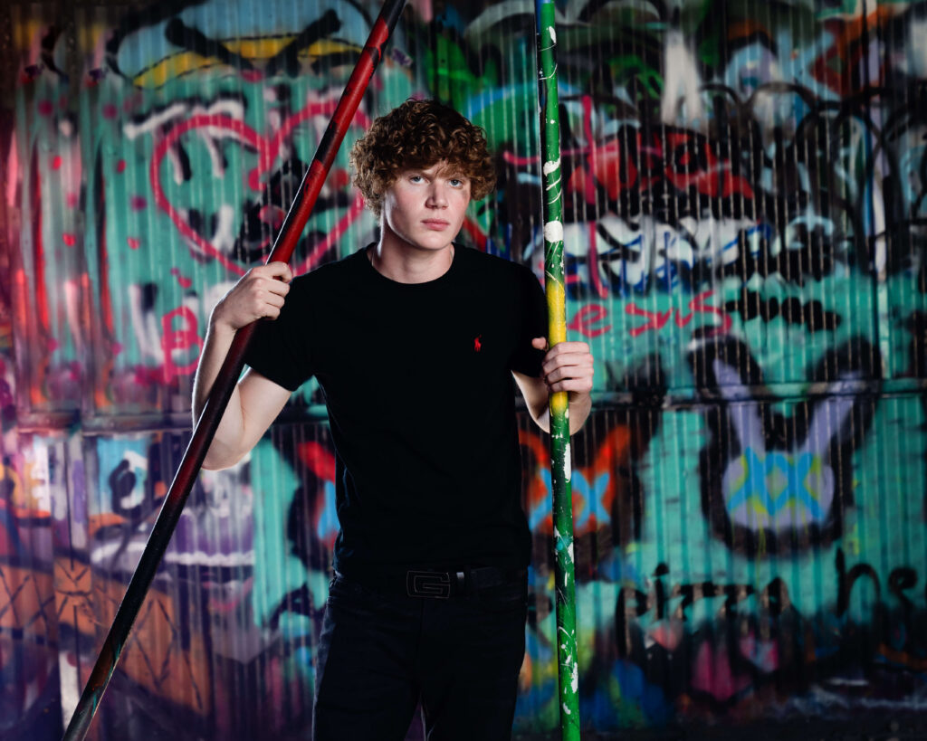 senior guy in urban setting with grafitti
