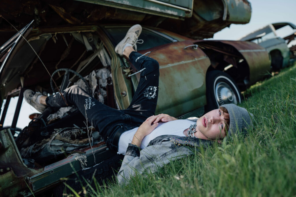 senior guy portrait in junk yard
